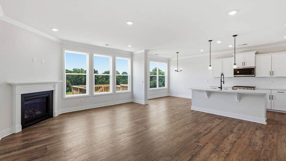Family room with large windows and fireplace.