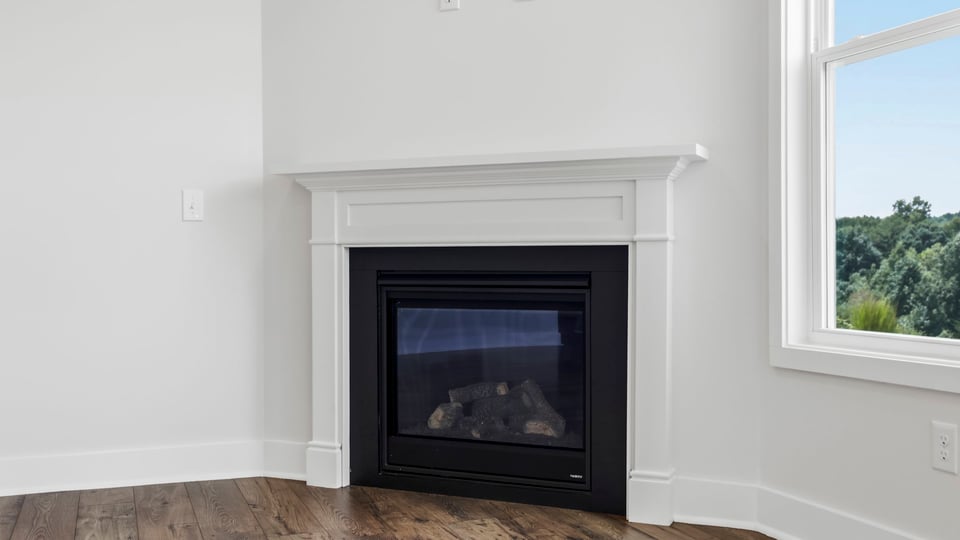 Family room with large windows and fireplace.