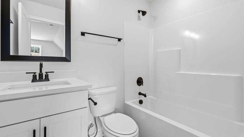 Bathroom with single vanity sink and bathtub.