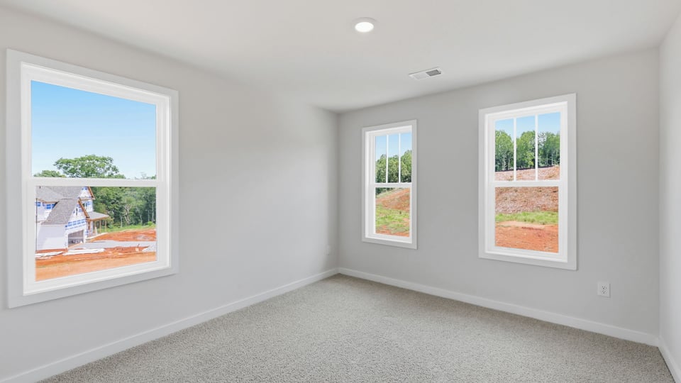 Bedroom with carpet and window.