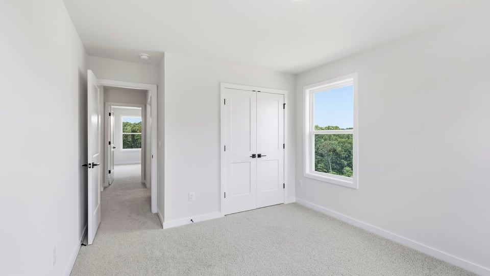 Bedroom with carpet and window.