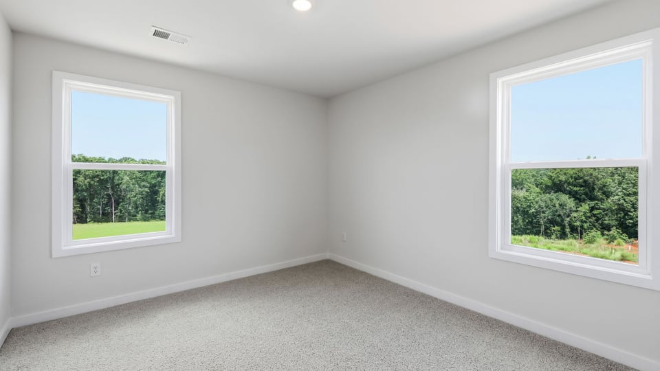Bedroom with carpet and window.