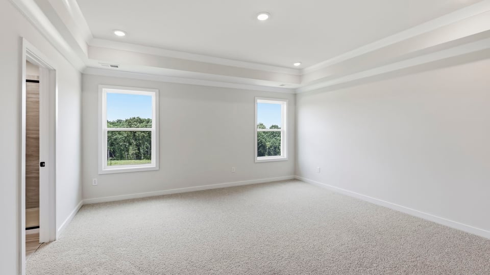Bedroom with carpet and window.