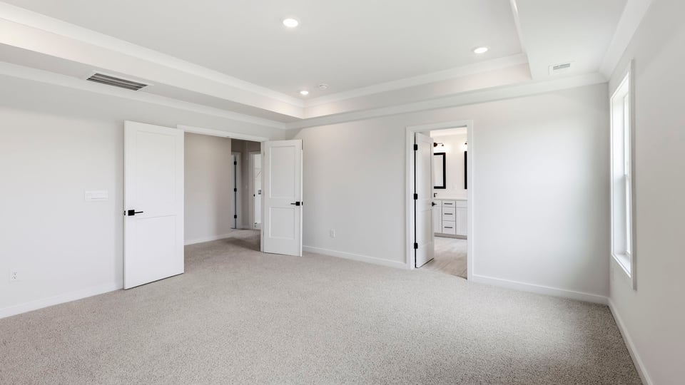 Bedroom with carpet and window.