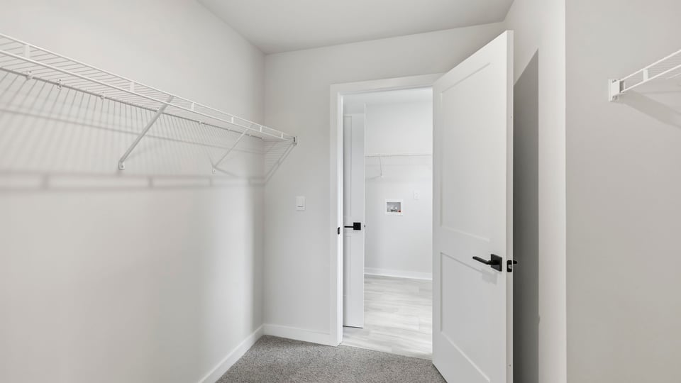 Closet with hanging storage racks.