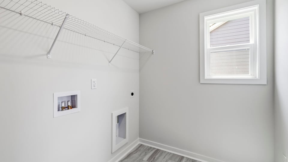Laundry room with hanging storage racks.