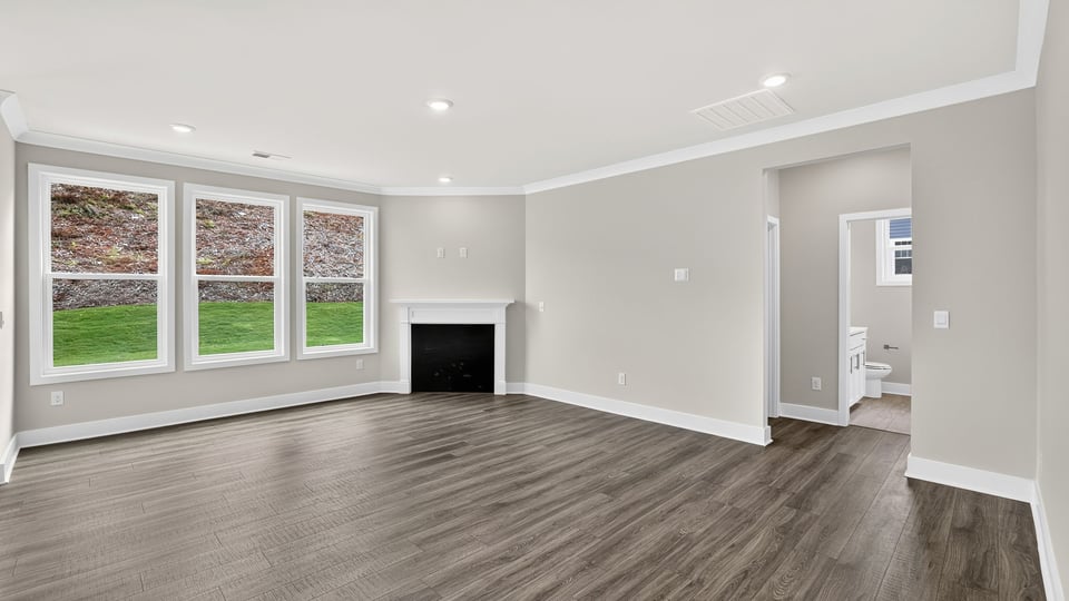Living room with windows and fireplace.
