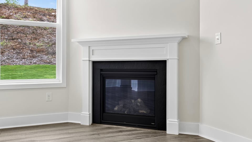 Living room with windows and fireplace.