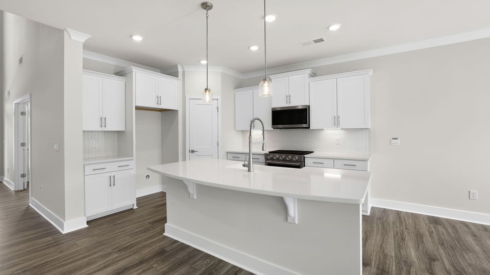 Kitchen and island with quartz countertops.