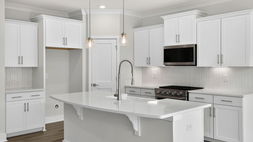 Kitchen and island with quartz countertops.