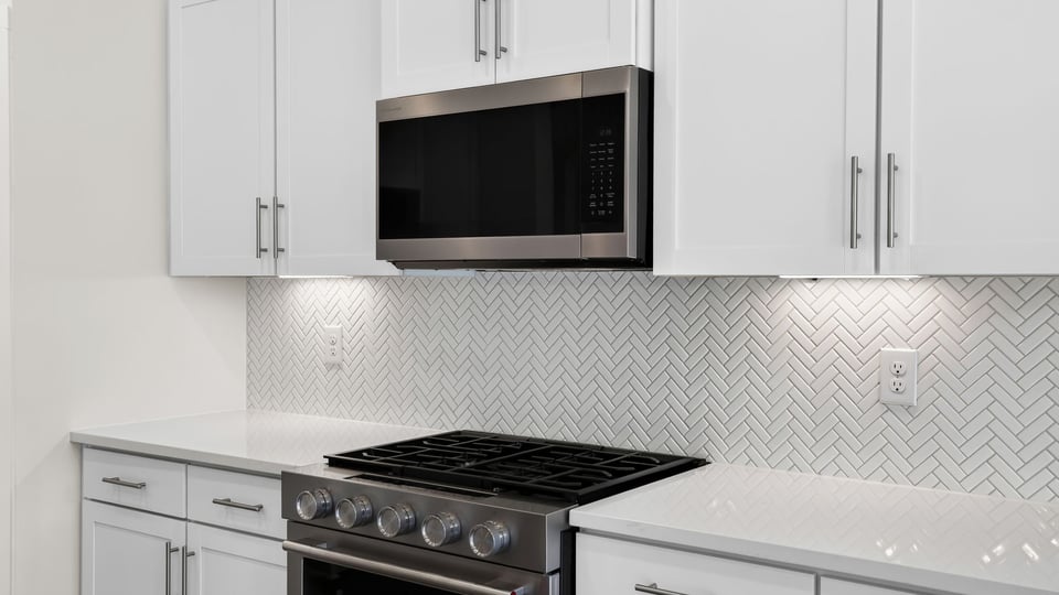 Kitchen and island with quartz countertops.