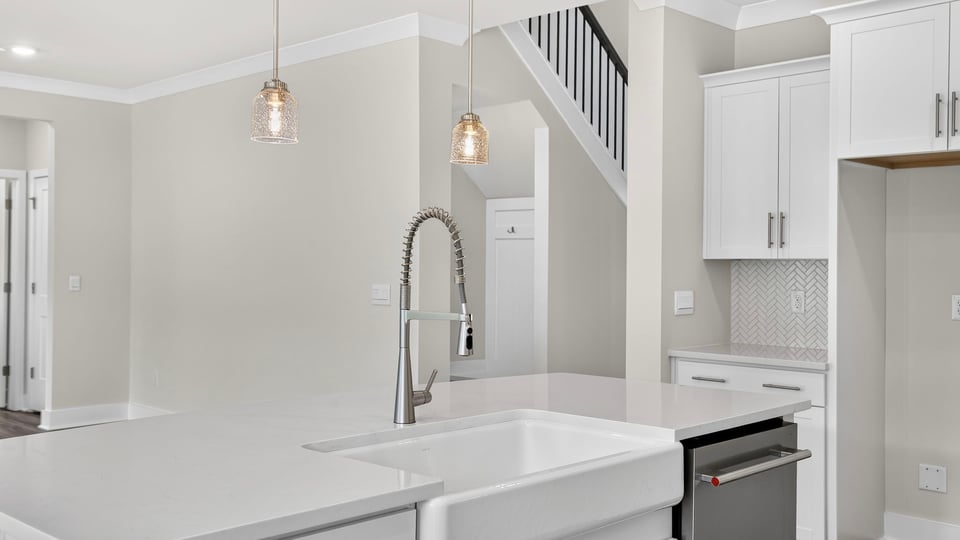 Kitchen and island with quartz countertops.