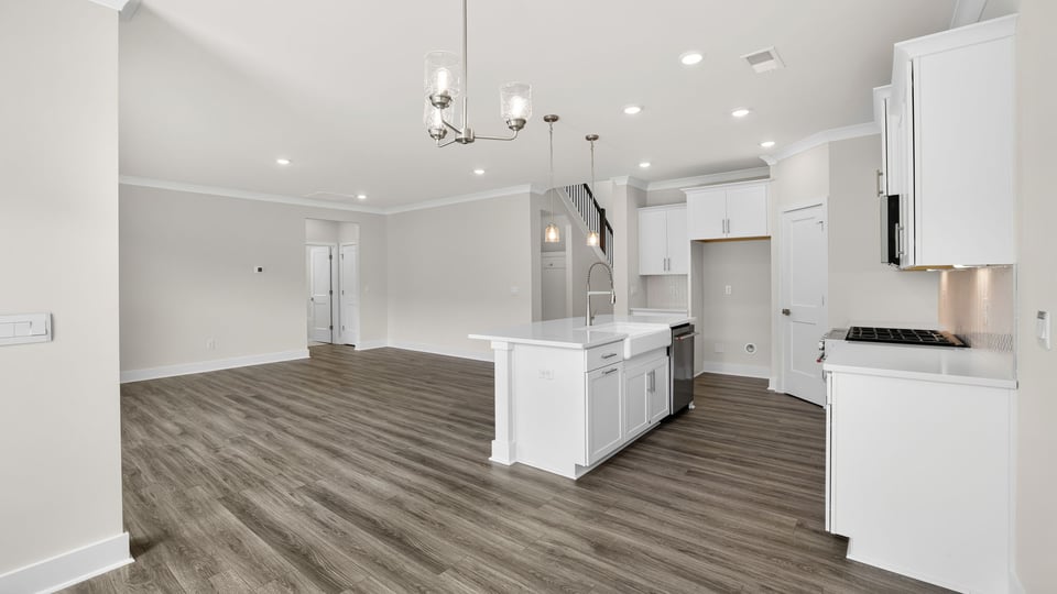 Kitchen and island with quartz countertops.