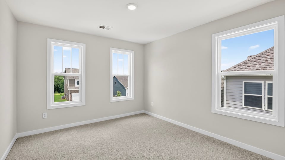 Bedroom with carpet and window.