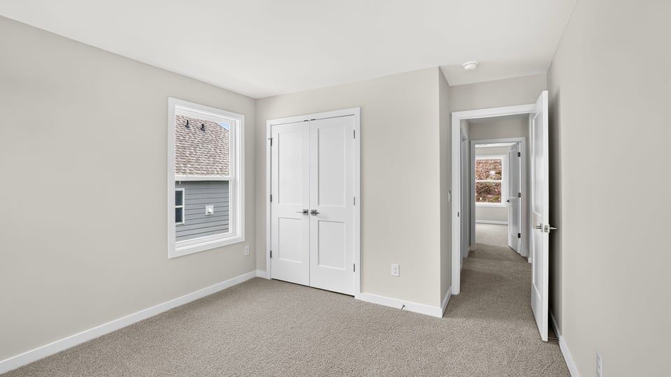 Bedroom with carpet and window.