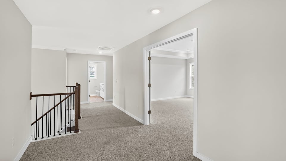 Loft area with carpet.