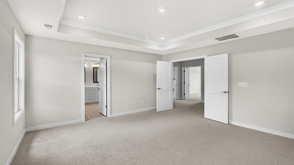 Bedroom with carpet and window.