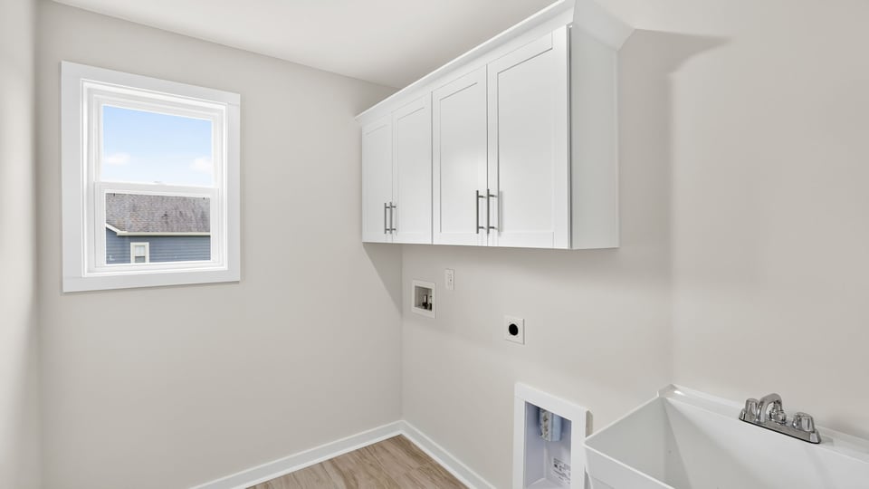 Laundry room with cabinets.