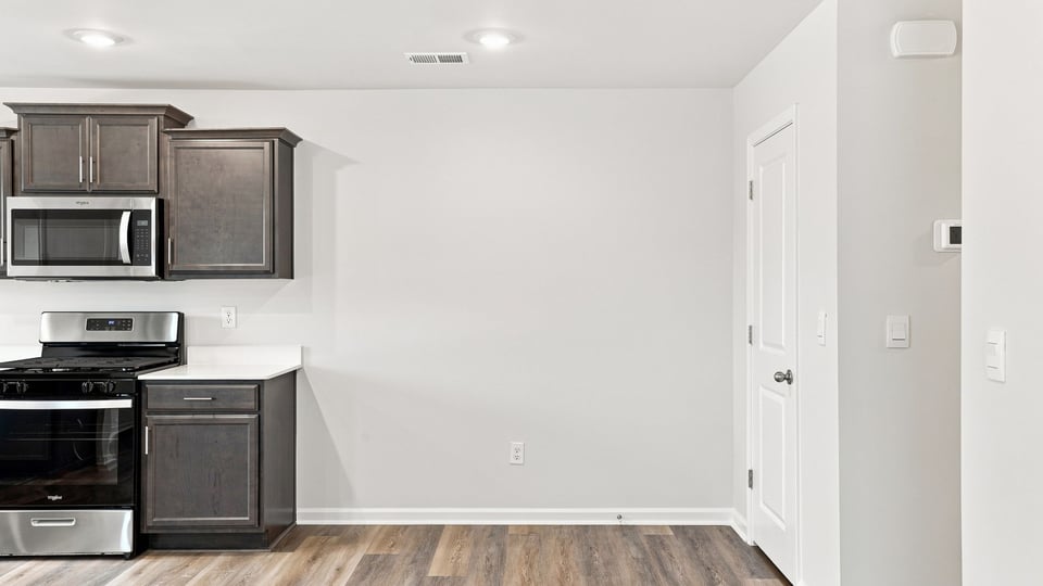 Kitchen with stainless steel appliances and window.