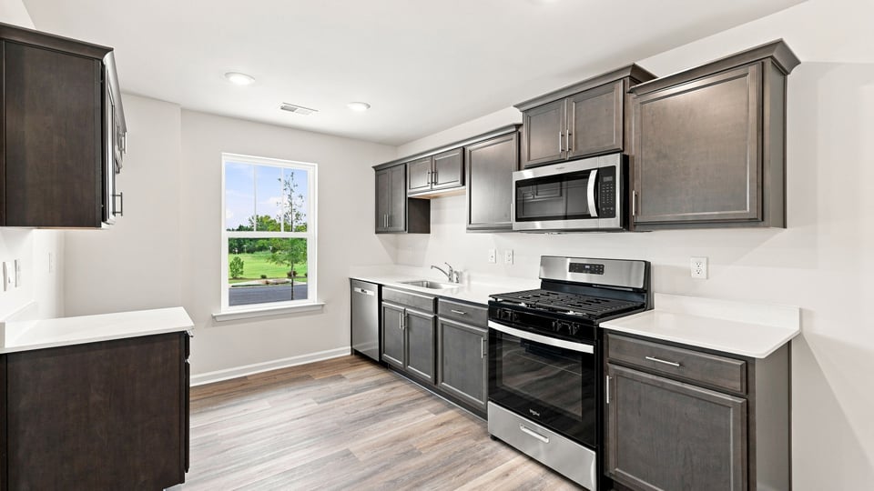 Kitchen with stainless steel appliances and window.