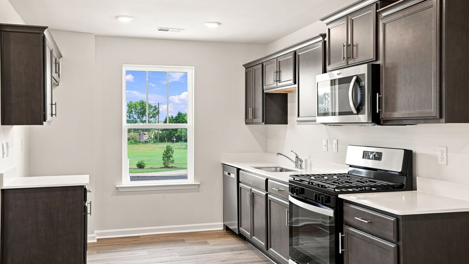 Kitchen with stainless steel appliances and window.