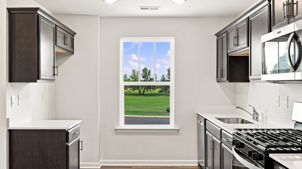 Kitchen with stainless steel appliances and window.