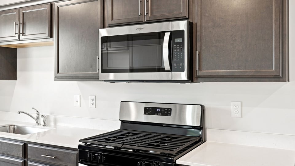 Kitchen with stainless steel appliances and window.