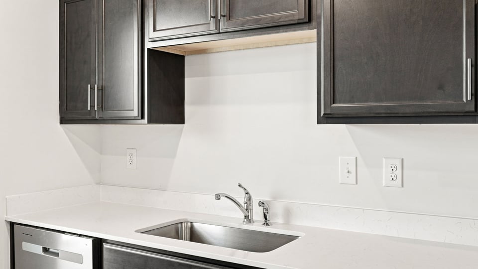 Kitchen with stainless steel appliances and window.
