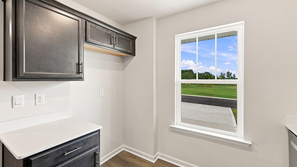 Kitchen with stainless steel appliances and window.