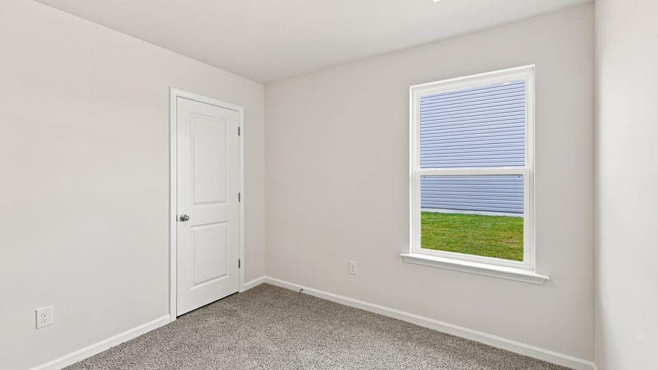 Bedroom with carpet and window.