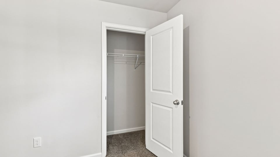 Bedroom with carpet and window.