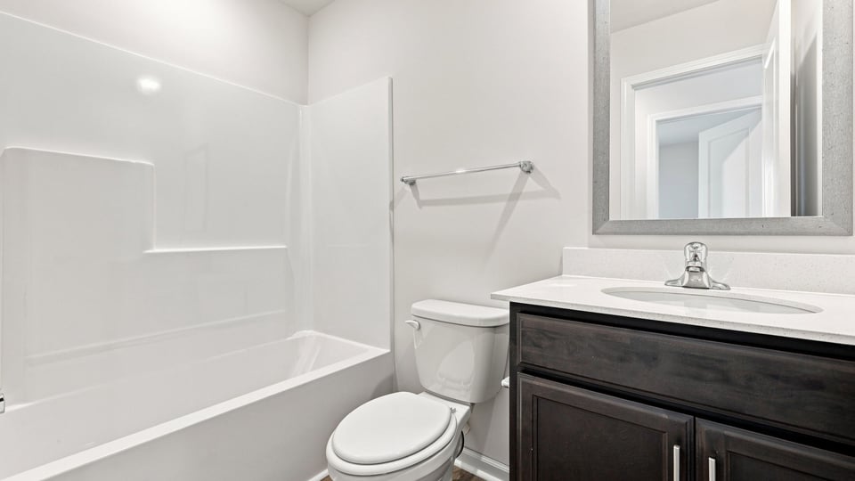 Bathroom with single vanity sink and bathtub.