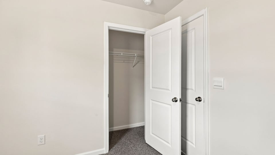 Bedroom with carpet and window.