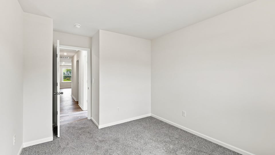 Bedroom with carpet and window.