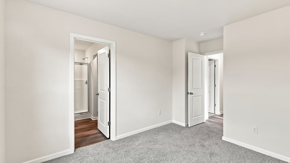 Bedroom with carpet and window.