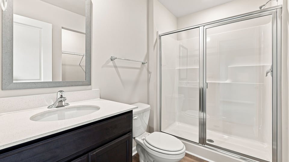 Bathroom with single vanity sink and walk in shower.