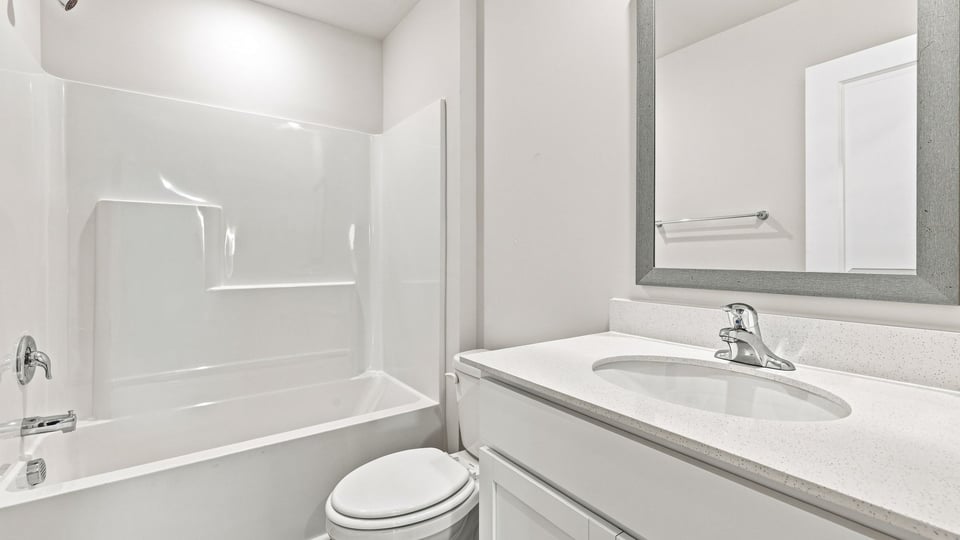 Bathroom with single vanity sink and bathtub.