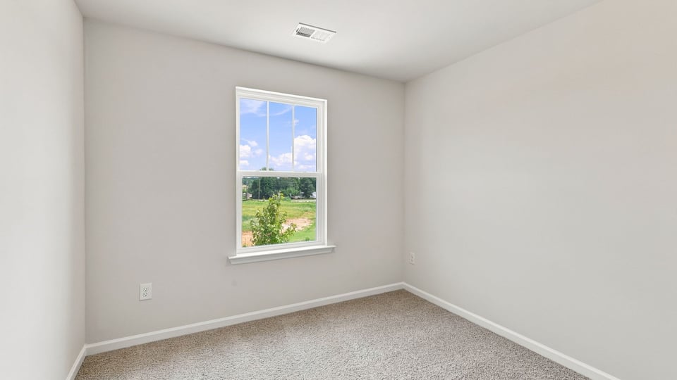 Bedroom with carpet and window.