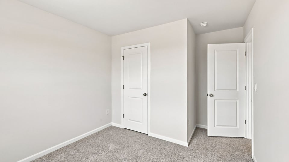 Bedroom with carpet and window.