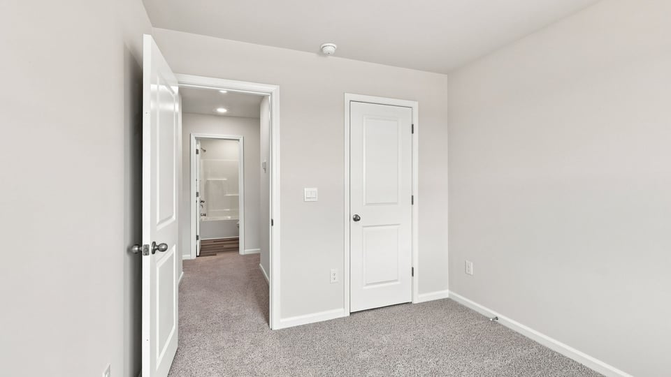 Bedroom with carpet and window.