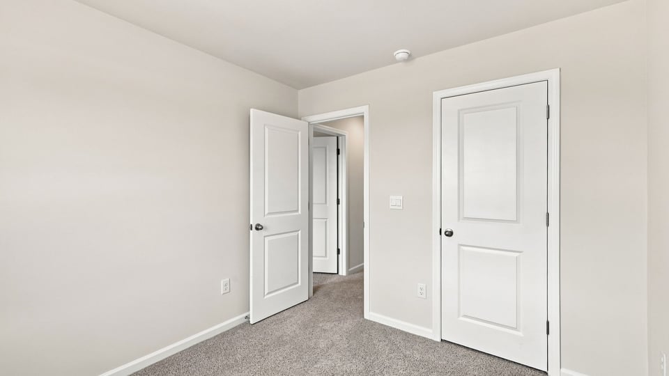 Bedroom with carpet and window.