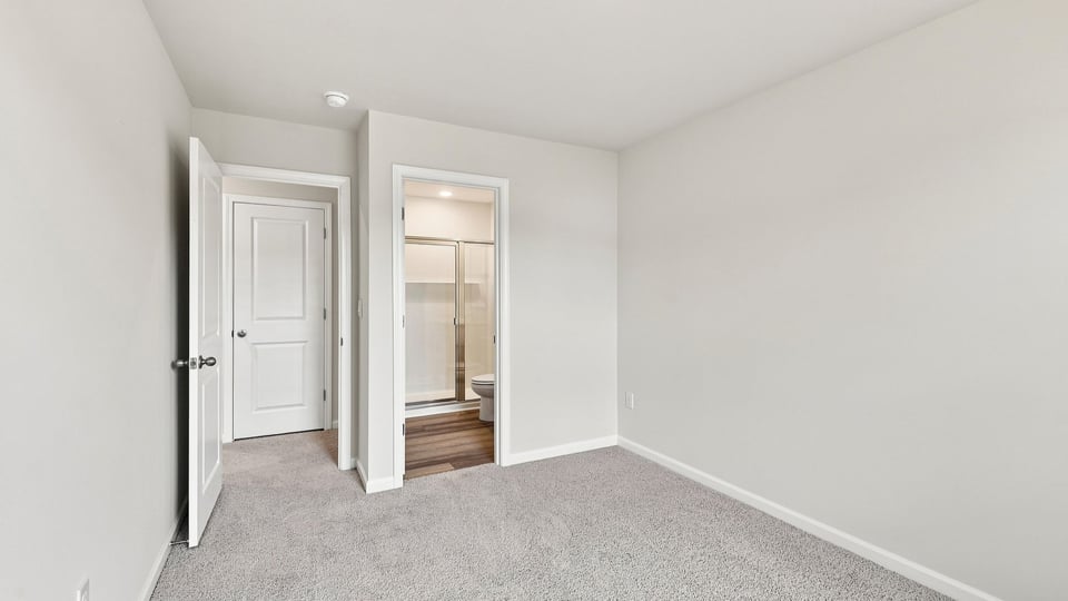 Bedroom with carpet and window.