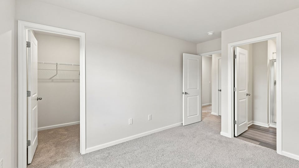 Bedroom with carpet and window.
