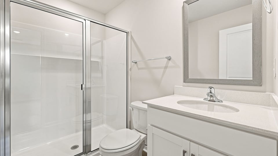 Bathroom with single vanity sink and walk in shower.