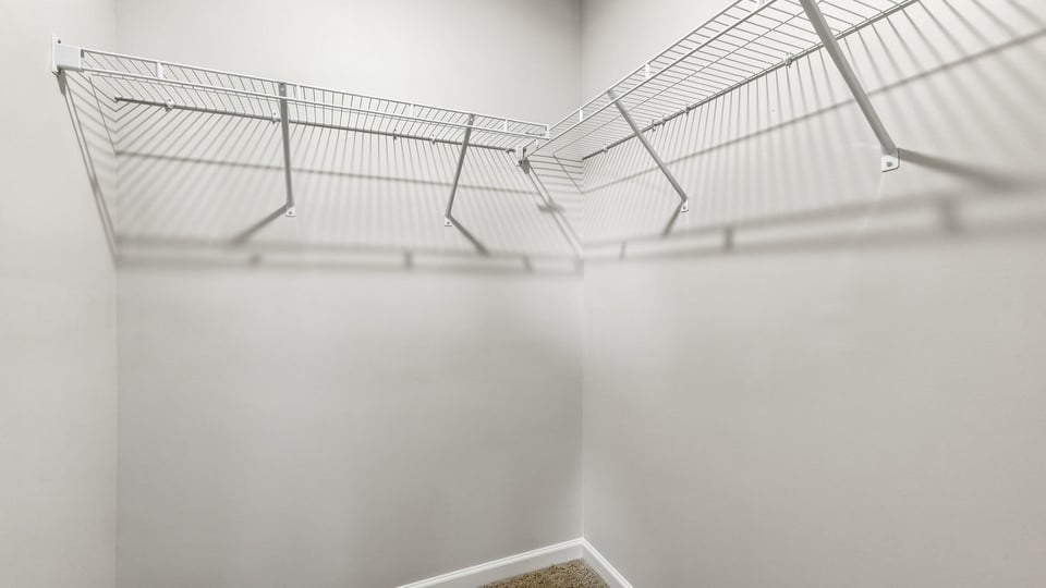 Closet with hanging storage racks.