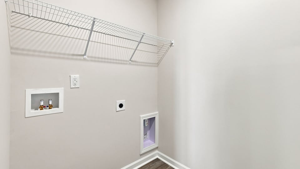 Laundry room with hanging storage racks.