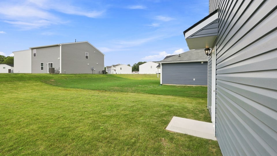 Back exterior of home with large backyard.
