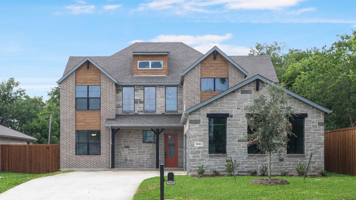 front exterior of a modern two story home featuring grey brick and stone