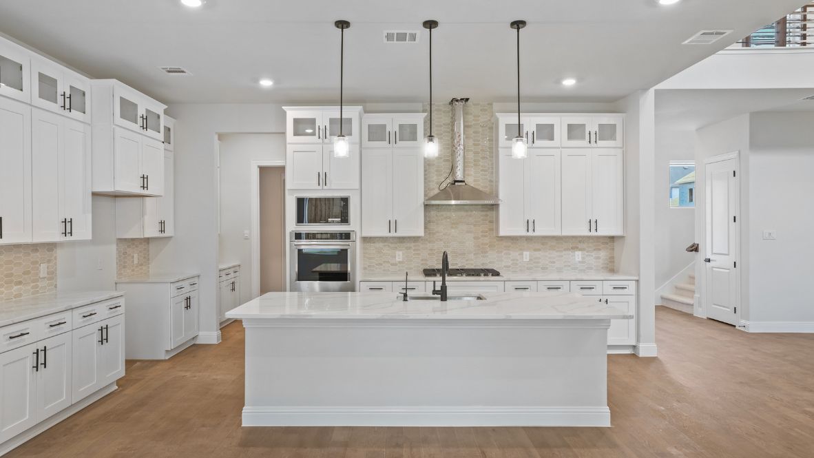 kitchen with white cabinetry, large island, and stainless steel appliances