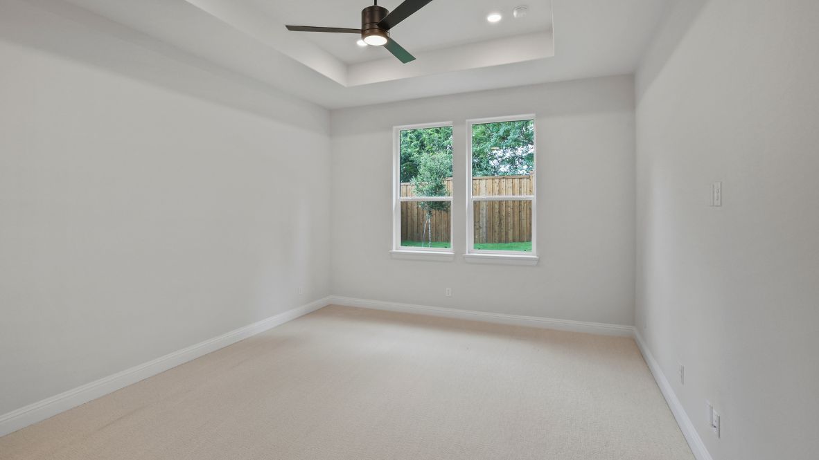 bedroom with beige carpet, white walls and a window